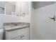 Small bathroom with white tile and granite countertop at 2434 Miriam Ln, Decatur, GA 30032