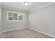 Spacious bedroom with neutral walls and carpet, featuring a large window at 2434 Miriam Ln, Decatur, GA 30032