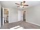 Main bedroom with carpet flooring, ceiling fan and ensuite bathroom at 2434 Miriam Ln, Decatur, GA 30032