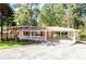 Brick ranch home with carport and landscaped yard at 504 Milligan Dr, Stone Mountain, GA 30083