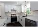 Modern kitchen with white cabinets, black hardware, and quartz countertops at 504 Milligan Dr, Stone Mountain, GA 30083