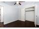 Well-lit bedroom featuring dark hardwood floors and a closet at 504 Milligan Dr, Stone Mountain, GA 30083