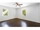Bright bedroom with dark hardwood floors and ceiling fan at 504 Milligan Dr, Stone Mountain, GA 30083