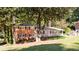 Two-story brick home with large yard and trees at 504 Milligan Dr, Stone Mountain, GA 30083