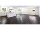 Renovated kitchen with white cabinets, island, and dark hardwood floors at 504 Milligan Dr, Stone Mountain, GA 30083