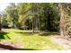 Wooded backyard with grassy area at 504 Milligan Dr, Stone Mountain, GA 30083