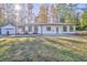 White modern farmhouse exterior with attached garage and grassy yard at 49 Allison Dr, Dallas, GA 30157