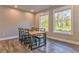 Light-filled dining room with hardwood floors and a rustic wooden table at 49 Allison Dr, Dallas, GA 30157