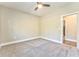 Well-lit bedroom with carpet, ceiling fan, and access to closet and bathroom at 49 Allison Dr, Dallas, GA 30157