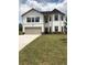 Two-story house with white siding, gray garage door, and manicured lawn at 3035 Chris Cir, Villa Rica, GA 30180