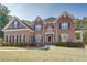 Brick two-story house with a large front yard and manicured landscaping at 2312 Mallory Cir, Conyers, GA 30094