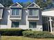 White two-story condo with gray accents and well-manicured landscaping at 25 Fair Haven Way, Smyrna, GA 30080