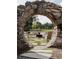 Relaxing outdoor patio area with stone arch and fire pit at 185 Roycroft Ln, Fayetteville, GA 30214