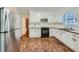 Kitchen with white cabinets, tile floor, and stainless steel appliances at 2459 Jacks View Ct, Snellville, GA 30078