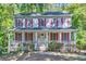 Two-story house with white siding, red shutters, and a wraparound porch at 2459 Jacks View Ct, Snellville, GA 30078
