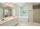 Main bathroom with double vanity, garden tub, and shower at 2459 Jacks View Ct, Snellville, GA 30078