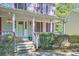 Inviting front porch with white railings and landscaping at 2459 Jacks View Ct, Snellville, GA 30078