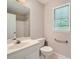 Clean bathroom with white vanity, toilet and shower/tub combo at 2459 Jacks View Ct, Snellville, GA 30078