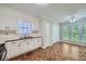 Kitchen with white cabinets, tile floor, and view of backyard at 2459 Jacks View Ct, Snellville, GA 30078