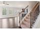 Carpeted staircase with wrought iron balusters leading to the second floor at 470 Paces Dr, Lithia Springs, GA 30122