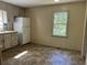 A kitchen with white cabinets, tiled backsplash, and white refrigerator at 6883 Lakeshore Dr, Douglasville, GA 30135