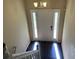 View of the home's entryway, featuring a white door and dark hardwood floors at 6883 Lakeshore Dr, Douglasville, GA 30135
