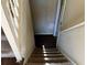 View of carpeted basement stairs with wooden railing at 6883 Lakeshore Dr, Douglasville, GA 30135