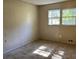 Simple bedroom with large window and carpet at 6883 Lakeshore Dr, Douglasville, GA 30135