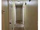 A long hallway with carpeted floors and multiple doors at 6883 Lakeshore Dr, Douglasville, GA 30135