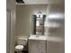 Small bathroom with vanity, toilet and mirror at 6883 Lakeshore Dr, Douglasville, GA 30135