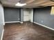 Unfinished basement room with dark gray walls and wood-look flooring at 6883 Lakeshore Dr, Douglasville, GA 30135