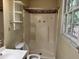 Small bathroom with shower, toilet and window at 6883 Lakeshore Dr, Douglasville, GA 30135