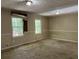 Living room with damaged walls and carpeting at 6883 Lakeshore Dr, Douglasville, GA 30135