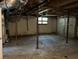 Unfinished basement garage with concrete floor and one window at 6883 Lakeshore Dr, Douglasville, GA 30135