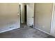 Bedroom with door to hallway and damaged wall at 6883 Lakeshore Dr, Douglasville, GA 30135