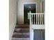 Image of a carpeted staircase with white railings leading to the second floor at 6883 Lakeshore Dr, Douglasville, GA 30135