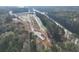 Aerial view of a community under construction, including roads, homes, and green spaces at 4525 Twinberry Dr, Powder Springs, GA 30127