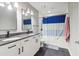 Bathroom with double vanity and blue shower curtain at 44 Peachtree Nw Pl # 834, Atlanta, GA 30309