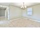 Spacious dining area with tile floors and a chandelier at 2933 Indian Shoals Rd, Dacula, GA 30019