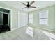 Well-lit bedroom with ceiling fan, double-door closet, and neutral walls at 430 Thornbush Trce, Lawrenceville, GA 30046