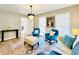 Bright living room with teal armchairs and a light beige sofa, featuring a large rug at 430 Thornbush Trce, Lawrenceville, GA 30046
