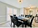Formal dining room with dark-colored chairs, a marble-top table, and large windows at 430 Thornbush Trce, Lawrenceville, GA 30046