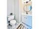 Updated bathroom with white vanity, marble floors, and oval mirror at 430 Thornbush Trce, Lawrenceville, GA 30046