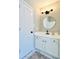 Updated bathroom with white vanity, marble floors, and a stylish mirror at 430 Thornbush Trce, Lawrenceville, GA 30046