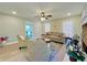Open living room with hardwood floors, a stone fireplace, and plenty of natural light at 430 Thornbush Trce, Lawrenceville, GA 30046