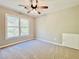 Spacious bedroom with neutral walls, new carpet, and large windows at 430 Thornbush Trce, Lawrenceville, GA 30046