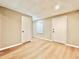 Finished basement with light wood flooring and multiple rooms at 430 Thornbush Trce, Lawrenceville, GA 30046