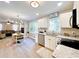 Open concept kitchen features stainless steel appliances and white cabinets at 430 Thornbush Trce, Lawrenceville, GA 30046