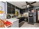 L-shaped kitchen with dark cabinets, tile floors, and ample counter space at 3208 Edgemont Way, Decatur, GA 30032