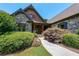 Inviting front entrance with stone accents and landscaping at 3128 Hidden Falls Dr, Buford, GA 30519